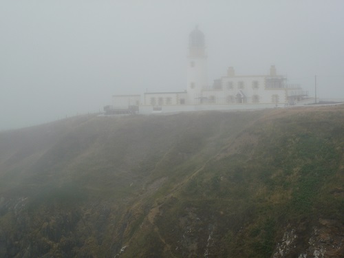 Killantringan Lighthouse, barely visible in the sea mist
