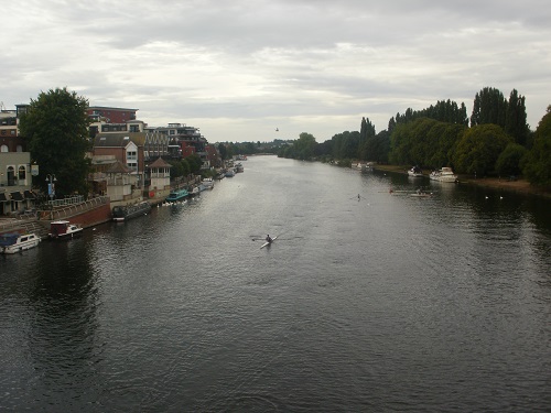 A lone canoeist passes under Kingston Bridge